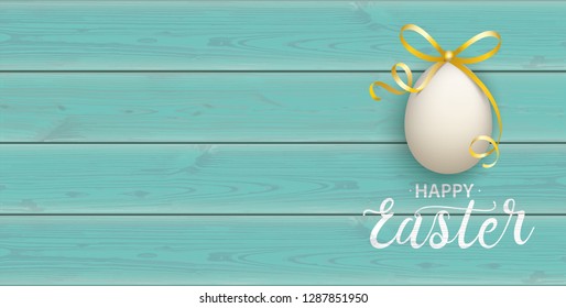 Easter egg with golden ribbon on the wooden background.  Eps 10 vector file.