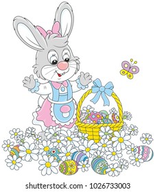 Easter egg hunt in flowers. Little bunny with a decorated basket collecting colorfully painted eggs among white daisies