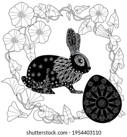 Easter egg hunt in flowers. Little bunny collecting painted eggs 
among flowers, a black and white vector illustration for a coloring book. Art therapy coloring page.