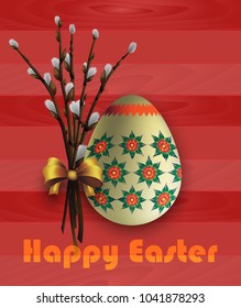 Easter egg on a wooden background and tender spring willows