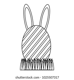 easter egg with rabbit ears on grass