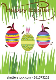 Easter eggs with Easter bunny ears hidden in the grass