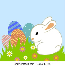 Easter eggs and bunny in grass on blue background
