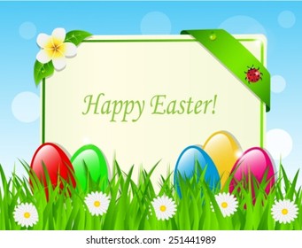 Easter eggs and card in the grass among the daisies