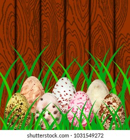 Easter. Eggs with different watercolor stains on the background of wood and grass. Place for text