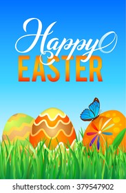 Easter eggs in Fresh Green Grass. Decorated Easter Eggs in Grass on Sky Background. Happy Easter Calligraphy Poster Template