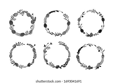 Easter eggs in grass in form of field wreath made of hand drawn meadow flowers, herbs, branches, twigs. Floral wreaths set. Botanical illustration. Vector illustration. 