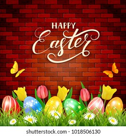 Easter eggs in grass on brick wall background with tulips, butterflies and ladybugs. Lettering Happy Easter, illustration.