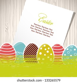Easter eggs with grass and paper