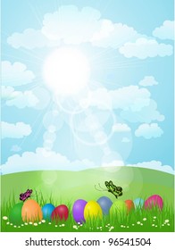Easter eggs in grass in a sunny landscape
