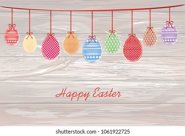 Easter eggs hang on a ribbon with bows. Greeting card or invitation for a holiday. Free space for text. Vector on wooden background.