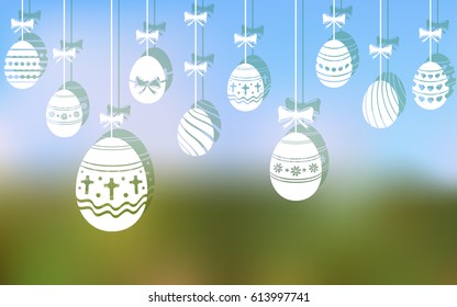 Easter eggs hanging ornaments on blurred background