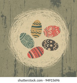 Easter eggs in nest on wooden texture. Easter background, retro styled.