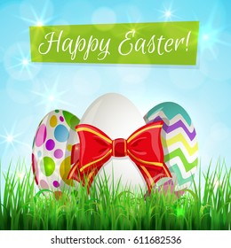 Easter eggs on grass and lettering -  Happy Easter. Vector.