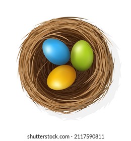 Easter eggs on wild bird nest from straw and twigs