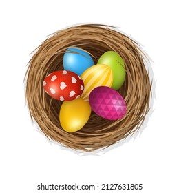 Easter eggs on wild bird nest from straw and twigs