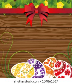  Easter eggs on the wooden fence background with  bow and flowers