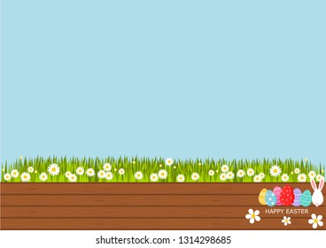 Easter eggs on wooden table with ear bunny, Space for your text