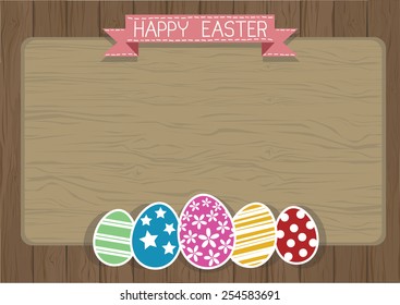 Easter eggs on a wooden wall background