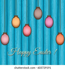 Easter eggs on a wooden wall background