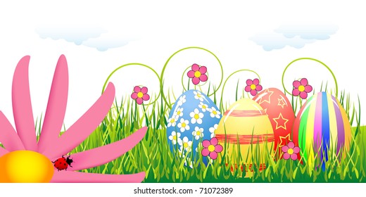 Easter eggs and pink flower in the grass under clouds