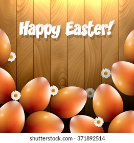 Easter eggs and small flowers on a wooden background.