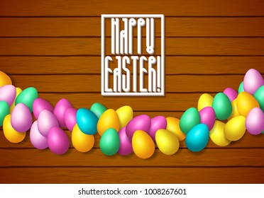 Easter frame with shiny colorful eggs spread over wooden background