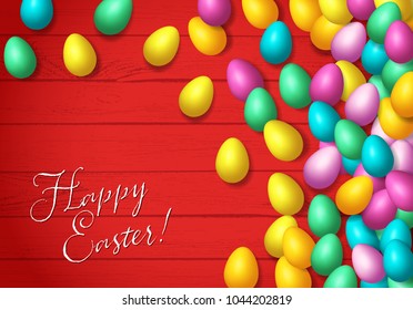 Easter frame with shiny colorful eggs spread over wooden background