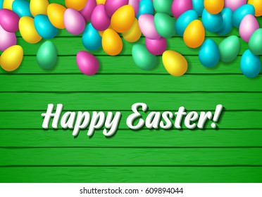 Easter frame with shiny colorful eggs spread over wooden background