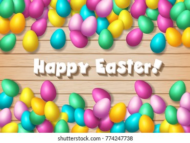 Easter frame with shiny colorful eggs spread over wooden background