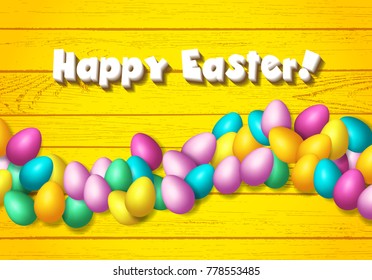 Easter frame with shiny colorful eggs spread over wooden background