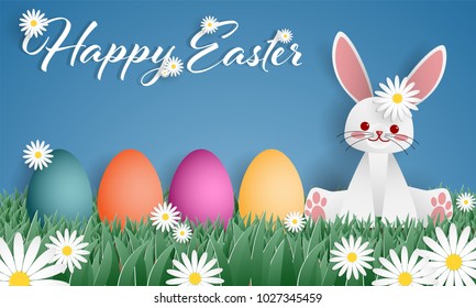 Easter greeting banner of a cute rabbit with rainbow Easter eggs on green grass field with white flowers and Happy Easter text on blue sky. Digital craft design in paper art style. Vector illustration