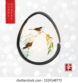 Easter greeting card in asian style. Little birds on bamboo branch in easter egg on white background. Traditional Japanese ink wash painting sumi-e. Hieroglyph - happiness.