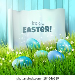 Easter greeting card with blue eggs and paper in the grass 