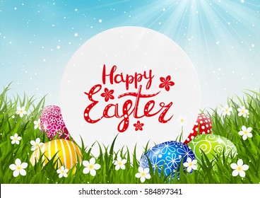 Easter greeting card with color eggs on green grass