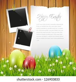 Easter greeting card with colorful eggs and empty paper on wooden background