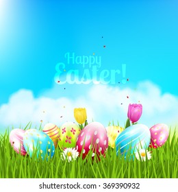 Easter greeting card with colorful eggs and flowers in the grass