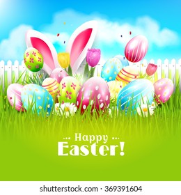 Easter greeting card with colorful eggs and bunny ears in the grass