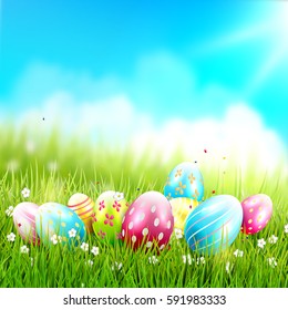 Easter greeting card with colorful eggs in the grass