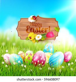 Easter greeting card - Easter eggs in the grass and wooden sign