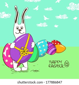 Easter greeting card with funny cartoon bunny rabbit and colorful eggs