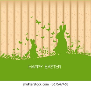 Easter greeting card with rabbit, gift and lights on the wooden background