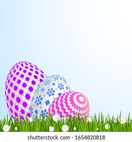 Easter greeting card template. Easter eggs on green grass with daisies. Bright sunny holiday card.