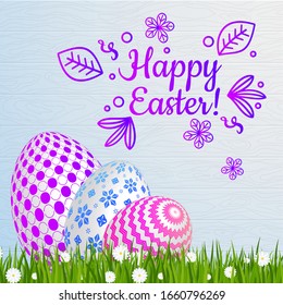 Easter greeting card template with with a funny congratulatory inscription. Lettering for cards. Easter eggs on green grass with daisies. Bright sunny holiday card.