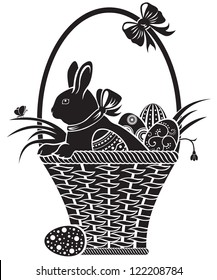 Easter hare sitting in a basket with eggs