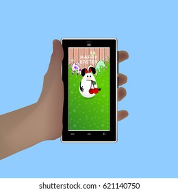 Easter. Hold in your hand a smart phone. Illustration for your design. Eared white rabbit-egg white in the mouth ripe cherry
