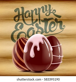 Easter holiday postcard with three decorated chocolate eggs isolated on wood background, vector realistic illustration with greeting lettering