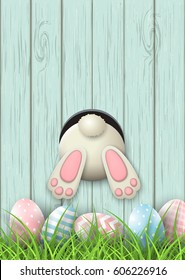 Easter motive, white bunny bottom and easter pink and blue eggs and fresh grass on blue wooden background, vector illustration, eps 10 with transparency and gradient meshes