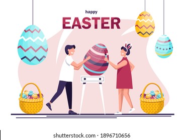 Easter. People decorating big Easter eggs. Happy man and woman in celebrating Easter and painting Easter eggs. Giant eggs and people preparing for a party.