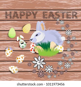 Easter. Easter rabbit with colored eggs in polka dots and stripes. on a wooden background. Easter inscription and flowers decoration